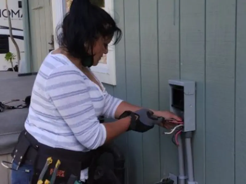 Licensed electrician wiring an exterior subpanel in Gouverneur